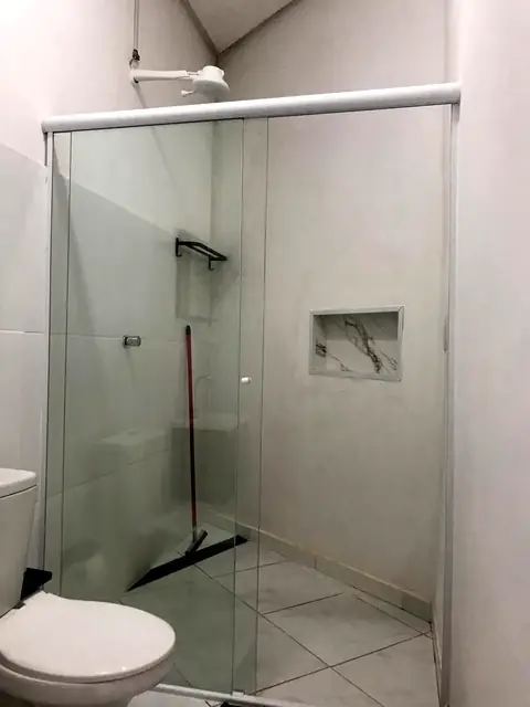 Banheiro com amplo box de vidro